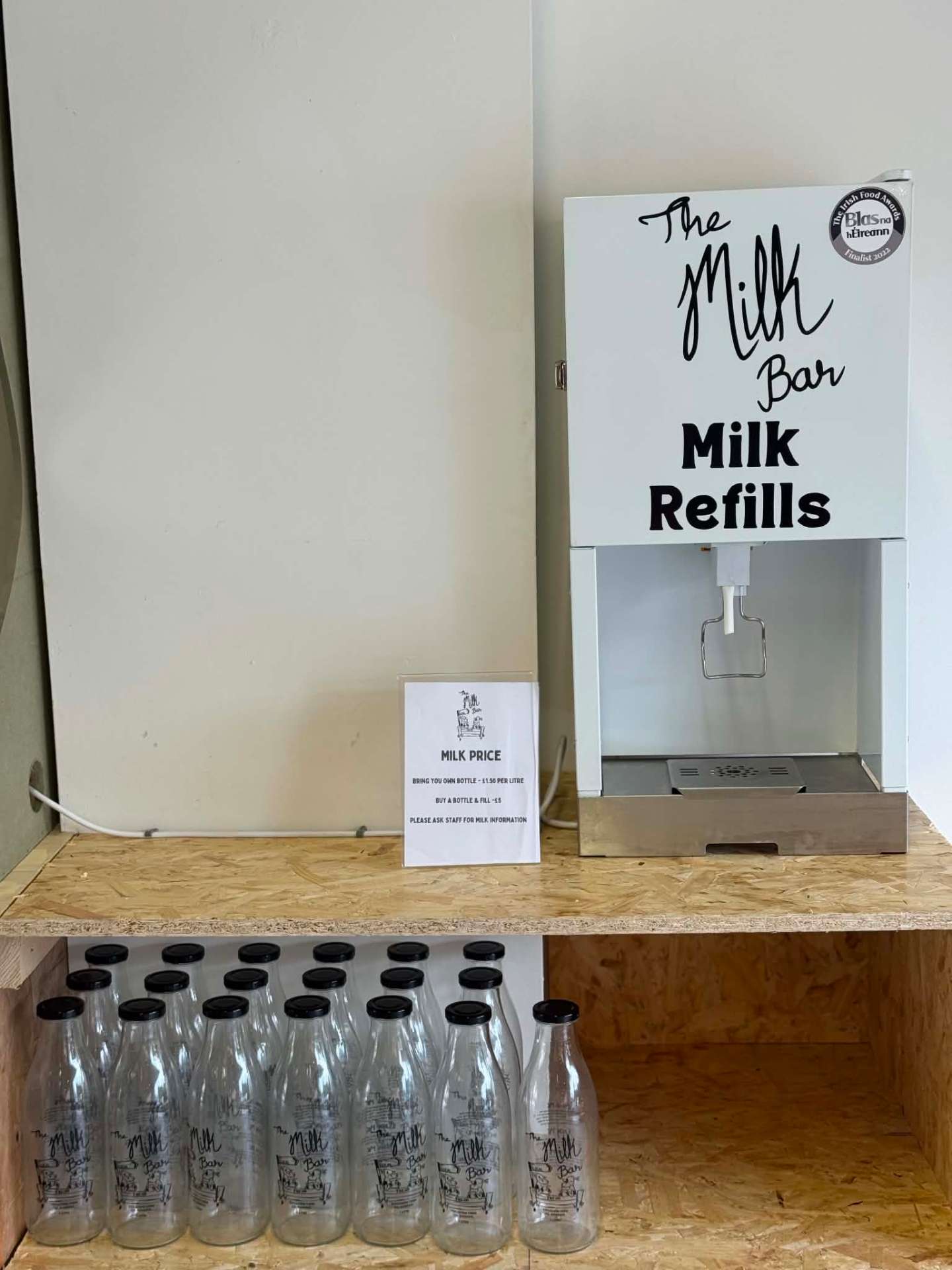 The Milk Bar self-serve milk refill station with glass bottles