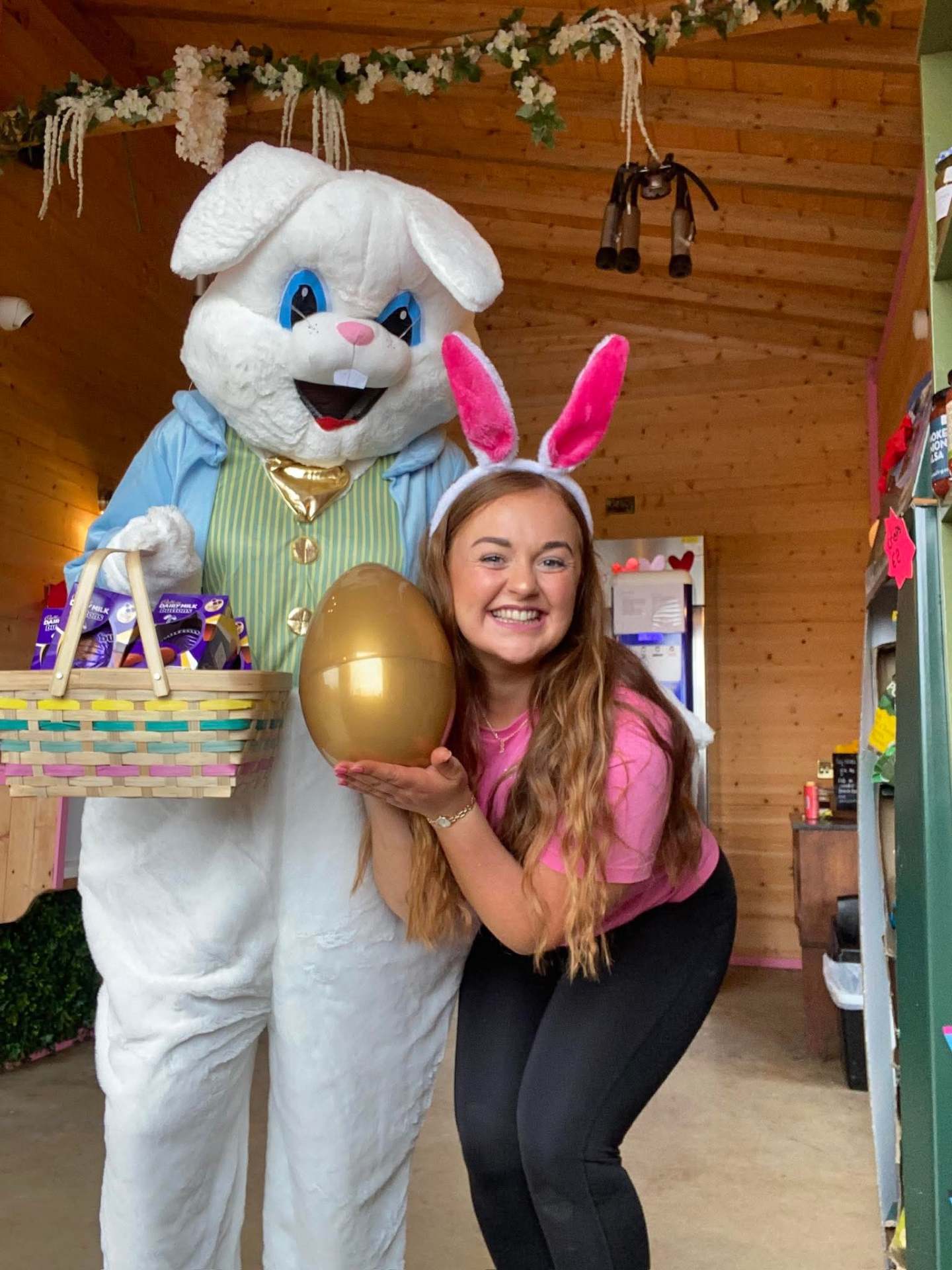 The Easter Bunny with a Milk Bar host holding a golden egg